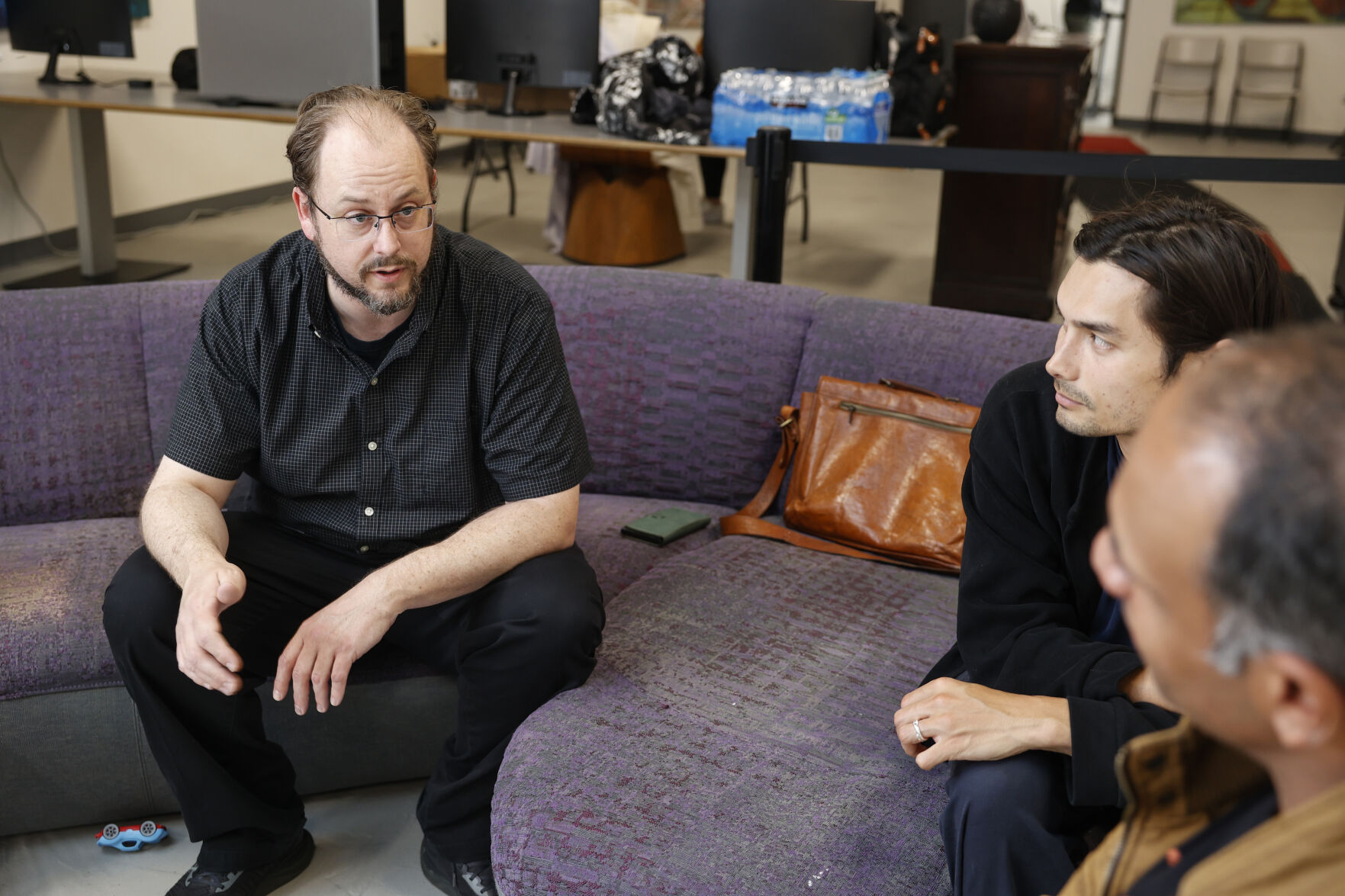 Pastor Dave Hodges (far left) of the Church of Ambrosia, speaking with Raff Poole (center) and Arun Sivanandam who both came to the first anniversary celebration of the Church’s Zide Door